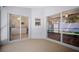 A screened-in lanai provides a relaxing outdoor space with sliding glass doors to the interior and a view of the backyard at 26501 Whirlaway Ter, Wesley Chapel, FL 33544
