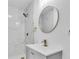 Modern bathroom features white marble walk-in shower and updated gold fixtures at 2711 E 22Nd Ave, Tampa, FL 33605