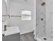 Updated bathroom with marble walk-in shower and sleek vanity with gray cabinets at 2711 E 22Nd Ave, Tampa, FL 33605