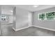 Bright bedroom with modern gray walls, light wood floors, and a window with natural light at 2711 E 22Nd Ave, Tampa, FL 33605