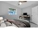 Serene bedroom featuring a work desk, a comfortable chair, and a window offering natural light at 2711 E 22Nd Ave, Tampa, FL 33605