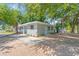 Attractive single-story house with gray siding, a concrete driveway, and complemented by fresh landscaping at 2711 E 22Nd Ave, Tampa, FL 33605