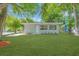 Inviting single-story home featuring a lush green lawn and a freshly painted exterior at 2711 E 22Nd Ave, Tampa, FL 33605
