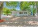 Well-maintained single-story house boasting a gray exterior, tidy landscaping, and a welcoming front entrance at 2711 E 22Nd Ave, Tampa, FL 33605
