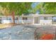 Charming single-story home featuring a gray exterior, well-manicured landscaping, and a spacious concrete driveway at 2711 E 22Nd Ave, Tampa, FL 33605