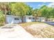 Inviting single-story home with gray exterior, mature trees, and a neatly kept lawn and driveway at 2711 E 22Nd Ave, Tampa, FL 33605