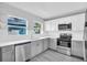 Updated kitchen featuring sleek stainless steel appliances and white cabinetry at 2711 E 22Nd Ave, Tampa, FL 33605