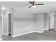 Spacious living room with new flooring, ceiling fan and a staircase at 2711 E 22Nd Ave, Tampa, FL 33605