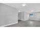 Open living room with gray walls, modern flooring, recessed lighting, and ample space for customization at 2711 E 22Nd Ave, Tampa, FL 33605