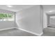Modern living room with gray walls, contemporary gray flooring, recessed lighting, and a large window at 2711 E 22Nd Ave, Tampa, FL 33605
