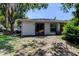 Home exterior featuring sliding glass doors opening onto the backyard at 2721 Baird Ct, Palm Harbor, FL 34684