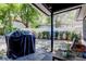 Backyard patio area with a table, chairs, and a barbeque at 2721 Baird Ct, Palm Harbor, FL 34684