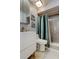 Modern bathroom featuring minimalist vanity, decorative artwork, and a shower with a shower curtain at 2721 Baird Ct, Palm Harbor, FL 34684