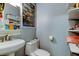 Cozy bathroom with toilet, bowl sink, and shelves at 2721 Baird Ct, Palm Harbor, FL 34684