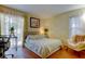 Bright bedroom with a light colored bed, and a large window that lets in lots of natural light at 2721 Baird Ct, Palm Harbor, FL 34684