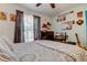 Comfortable bedroom featuring a bed, a ceiling fan, and a workspace at 2721 Baird Ct, Palm Harbor, FL 34684