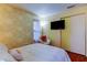 Bedroom featuring a queen bed, flat-screen television and a comfortable chair at 2721 Baird Ct, Palm Harbor, FL 34684