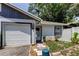 Charming home exterior with attached garage and landscaped front yard at 2721 Baird Ct, Palm Harbor, FL 34684