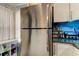 Kitchen featuring stainless steel refrigerator and modern white cabinets with grey countertops at 2721 Baird Ct, Palm Harbor, FL 34684