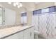 Modern bathroom featuring a granite countertop and a shower with stylish curtain at 3023 Minuteman Ln, Brandon, FL 33511