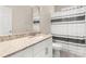Bright bathroom featuring a modern vanity and shower with black and white striped curtain at 3023 Minuteman Ln, Brandon, FL 33511