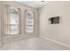 Bright bedroom with large windows providing ample natural light and mounted TV at 3023 Minuteman Ln, Brandon, FL 33511