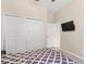 Cozy bedroom features a double bed, closet and mounted TV at 3023 Minuteman Ln, Brandon, FL 33511