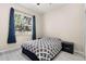 Well-lit bedroom featuring a large window and a sleek modern design at 3023 Minuteman Ln, Brandon, FL 33511