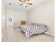 Bright bedroom featuring a ceiling fan and view into the connected bathroom at 3023 Minuteman Ln, Brandon, FL 33511