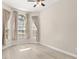 Sunlit bedroom with wide windows, ceiling fan and neutral color scheme at 3023 Minuteman Ln, Brandon, FL 33511