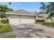 Exterior shot of a home with a large driveway and two-car garage at 3023 Minuteman Ln, Brandon, FL 33511