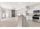 Kitchen with white cabinets and stainless steel appliances, open to the living area at 3023 Minuteman Ln, Brandon, FL 33511