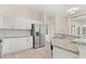 Bright kitchen featuring stainless steel appliances, white cabinets, and granite countertops at 3023 Minuteman Ln, Brandon, FL 33511