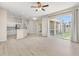 Open-concept living room with sliding glass doors leading to the backyard and adjoining kitchen at 3023 Minuteman Ln, Brandon, FL 33511