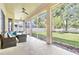 Relax on the covered patio with ceiling fans and outdoor seating, overlooking the lawn at 3023 Minuteman Ln, Brandon, FL 33511