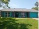 Charming single-story home featuring a colorful exterior and well-maintained front lawn at 3317 Honeymoon Ln, Holiday, FL 34691