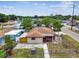An aerial view showing the home's fenced yard, landscaping, and proximity to the street and other houses at 3324 W Saint Joseph St, Tampa, FL 33607