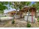 The backyard has a covered dining area, fence, and mature trees at 3324 W Saint Joseph St, Tampa, FL 33607