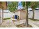 Backyard with detached structure, white fence, and mature trees at 3324 W Saint Joseph St, Tampa, FL 33607