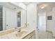 Bright bathroom with a marble countertop vanity and doorway into the hallway at 3324 W Saint Joseph St, Tampa, FL 33607