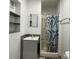 Updated bathroom features a shower with leafy curtain and gray vanity at 3324 W Saint Joseph St, Tampa, FL 33607