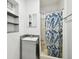 Bathroom featuring new shower with leafy curtain and gray vanity at 3324 W Saint Joseph St, Tampa, FL 33607