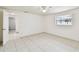 Well-lit bedroom features tile flooring, neutral colors, and natural light at 3324 W Saint Joseph St, Tampa, FL 33607