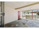 Open carport with a red door and patterned concrete blocks at 3324 W Saint Joseph St, Tampa, FL 33607