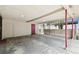 Spacious carport with red support beams and a red door at 3324 W Saint Joseph St, Tampa, FL 33607