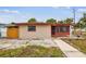 This single-story residence boasts a red trim, security bars on the windows, and a walkway at 3324 W Saint Joseph St, Tampa, FL 33607