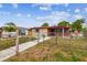 Charming single-story home featuring a fenced yard and a welcoming walkway to the front entrance at 3324 W Saint Joseph St, Tampa, FL 33607
