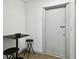Hallway with a small table, chairs, and a closed white door at 3324 W Saint Joseph St, Tampa, FL 33607