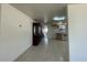 Hallway with tile flooring, a china cabinet, and an open view into the kitchen space at 3324 W Saint Joseph St, Tampa, FL 33607
