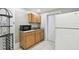 Efficient kitchen with microwave, stainless steel sink, and white tile backsplash at 3324 W Saint Joseph St, Tampa, FL 33607